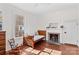 Cozy bedroom with hardwood floors, a fireplace, and a window overlooking the front yard at 506 S Church St, Salisbury, NC 28144