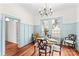 Inviting dining room features a vintage dining set, wainscoting, and two windows at 506 S Church St, Salisbury, NC 28144