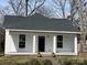 Charming home featuring a classic white exterior, inviting front porch with columns, and well-maintained landscaping at 506 S Church St, Salisbury, NC 28144