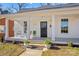 Charming white home featuring a cozy front porch with classic columns and a walkway leading to the entrance at 506 S Church St, Salisbury, NC 28144