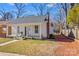 Charming white home featuring a cozy front porch with classic columns and a walkway leading to the entrance at 506 S Church St, Salisbury, NC 28144