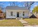 Charming white home featuring a cozy front porch with classic columns and a walkway leading to the entrance at 506 S Church St, Salisbury, NC 28144