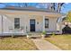 Charming white home featuring a cozy front porch with classic columns and a walkway leading to the entrance at 506 S Church St, Salisbury, NC 28144