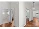 Hallway with hardwood floors and white walls leads to various rooms at 506 S Church St, Salisbury, NC 28144