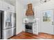 Bright kitchen with stainless steel appliances and white cabinets and a door at 506 S Church St, Salisbury, NC 28144