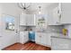 Updated kitchen featuring white cabinetry, stainless steel appliances, granite countertops, and hardwood floors at 506 S Church St, Salisbury, NC 28144