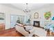 Inviting living room features hardwood floors, fireplace, elegant lighting, and French doors to adjoining spaces at 506 S Church St, Salisbury, NC 28144