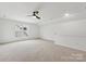 Upstairs bonus room with neutral carpet, white walls, ceiling fan, and natural light at 529 Veloce Trl, Fort Mill, SC 29715