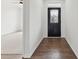 Inviting entryway with a dark wood door, hardwood floors, and bright white walls at 529 Veloce Trl, Fort Mill, SC 29715