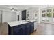 Open concept kitchen island with stainless steel appliances, quartz countertops and a view of a fireplace at 529 Veloce Trl, Fort Mill, SC 29715