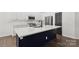 Elegant kitchen island offers a white countertop and a deep blue base with stainless appliances at 529 Veloce Trl, Fort Mill, SC 29715