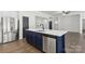 Modern kitchen island boasts a quartz countertop, stainless steel appliances, and a navy blue base at 529 Veloce Trl, Fort Mill, SC 29715