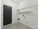 Laundry room featuring a dark door, tile floors, and wire shelving for storage at 529 Veloce Trl, Fort Mill, SC 29715