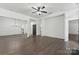 Spacious living room with hardwood floors, white walls, and contemporary light fixtures at 529 Veloce Trl, Fort Mill, SC 29715