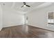 A well-lit main bedroom with hardwood floors, a ceiling fan, a tray ceiling, and bright white walls at 529 Veloce Trl, Fort Mill, SC 29715