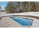 Backyard view featuring a pool with a concrete surround, metal handrail, and a white fence to the rear at 529 Veloce Trl, Fort Mill, SC 29715