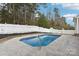 Inground pool with ladder and concrete border surrounded by mulch and white fence at 529 Veloce Trl, Fort Mill, SC 29715