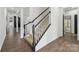 Elegant staircase with carpeted steps and white and black banisters leads to the upper level at 529 Veloce Trl, Fort Mill, SC 29715