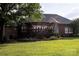 A delightful backyard features a spacious deck with pergola, a brick exterior, and lush greenery for outdoor enjoyment at 5645 White Store Rd, Wingate, NC 28174