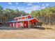 Red barn with multiple stalls and a covered area at 5645 White Store Rd, Wingate, NC 28174