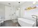 Modern bathroom with a soaking tub, glass shower, and gray tile floors at 5645 White Store Rd, Wingate, NC 28174