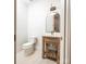 Small bathroom with a modern vanity and arched mirror at 5645 White Store Rd, Wingate, NC 28174