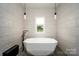 Spa-like bathroom with a modern, geometric-shaped soaking tub at 5645 White Store Rd, Wingate, NC 28174