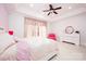 Bright bedroom with a ceiling fan, soft pink bedding and plenty of natural light at 5645 White Store Rd, Wingate, NC 28174