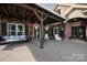 Relaxing covered porch with seating area, swing, and hanging flower baskets at 5645 White Store Rd, Wingate, NC 28174