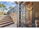 Ornate door leading to backyard with stone wall and pool at 5645 White Store Rd, Wingate, NC 28174