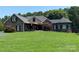 Charming two-story stone and brick home featuring a landscaped yard and covered front porch, perfect for relaxing outdoors at 5645 White Store Rd, Wingate, NC 28174