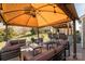 Backyard patio with outdoor bar, patio seating and umbrella coverage at 5826 Castlecove Rd, Charlotte, NC 28273