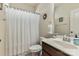 Well lit bathroom with a shower and dark wood vanity at 5826 Castlecove Rd, Charlotte, NC 28273