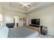 This inviting bedroom features a ceiling fan, neutral colors and an ensuite bath at 5826 Castlecove Rd, Charlotte, NC 28273