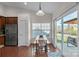 Bright dining area features a long table, a sliding glass door and stainless steel refrigerator at 5826 Castlecove Rd, Charlotte, NC 28273