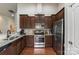 Gourmet kitchen with stainless steel appliances, granite countertops, and rich wood cabinets, great for cooking at 5826 Castlecove Rd, Charlotte, NC 28273