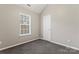 Spacious bedroom with a window, closet, and neutral walls at 5851 Brookfield Pointe Dr, Charlotte, NC 28216