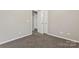 Simple bedroom with carpet, closet, and access to hallway at 5851 Brookfield Pointe Dr, Charlotte, NC 28216