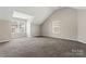 Bedroom with vaulted ceiling, carpet, and window at 5851 Brookfield Pointe Dr, Charlotte, NC 28216