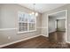 Bright dining area with chair railing and laminate wood floors at 5851 Brookfield Pointe Dr, Charlotte, NC 28216