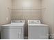 Bright laundry room with washer, dryer, and shelving at 5851 Brookfield Pointe Dr, Charlotte, NC 28216