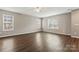 Spacious living area with dark laminate floors and lots of natural light at 5851 Brookfield Pointe Dr, Charlotte, NC 28216