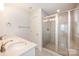 Bathroom with double sink vanity, brushed bronze fixtures, framed mirror, and walk-in shower at 604 Amalfi Dr, Davidson, NC 28036