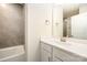 Bathroom with white vanity and bathtub with gray tile surround at 604 Amalfi Dr, Davidson, NC 28036