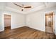 Spacious bedroom with wood-look floors, ceiling fan, and ensuite bathroom with tiled shower at 604 Amalfi Dr, Davidson, NC 28036