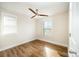 Bedroom featuring wood-look floors, ceiling fan, and bright windows at 604 Amalfi Dr, Davidson, NC 28036