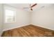 Bedroom featuring hardwood floors, white walls, and window with natural light at 604 Amalfi Dr, Davidson, NC 28036