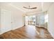 Bedroom featuring tray ceiling, ceiling fan, wood-look floors, and doors opening to private balcony at 604 Amalfi Dr, Davidson, NC 28036