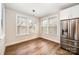 Bright breakfast nook with a modern light fixture, hardwood floors, and stainless steel refrigerator at 604 Amalfi Dr, Davidson, NC 28036