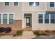 Inviting front entrance with a stained wood door, brick accents, and well-manicured landscaping at 604 Amalfi Dr, Davidson, NC 28036